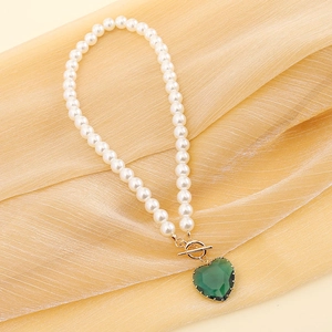 Elegant pearl necklace with faceted green heart pendant and gold OT toggle clasp