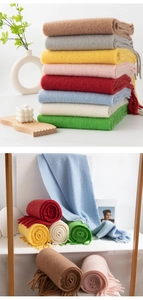 Multiple colorful wool scarves with fringes shown in various folded and rolled styles