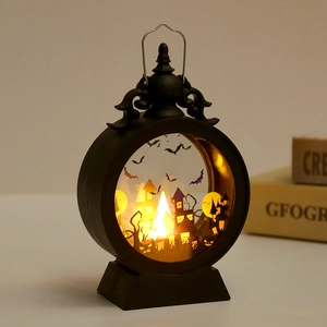 Detail of a black Halloween lantern with bat and castle silhouettes and warm LED light