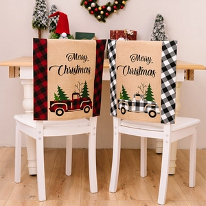 Detail of linen Christmas chair covers with buffalo plaid and vintage truck motifs