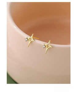 Macro detail of S925 sterling silver star stud earrings with a tiny zircon center