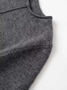 Macro shot of dark grey soft ribbed knit fabric showing neckline and seam details