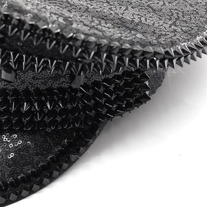 Macro detail of punk style black sequins and sharp metallic studs on a party captain hat