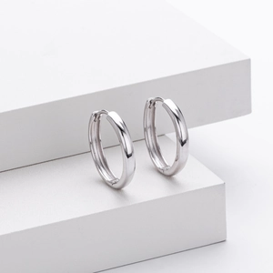 Macro shot of polished S925 sterling silver hoop earrings with classic hinge closure