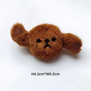 Détail d'écusson de chiot en peluche marron de 9,5cm avec texture douce et broderie