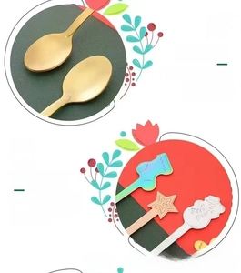 Close-up of stainless steel Christmas spoons with festive star and snowman handle designs