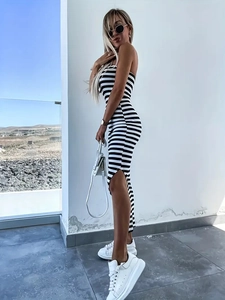 Detail of slim fit knit tube dress featuring black and white stripes and side slit