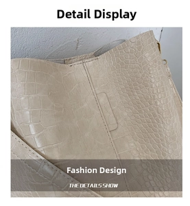 Detailed close-up of beige crocodile pattern texture and premium stitching on shoulder bag