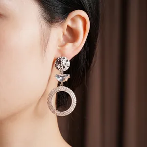 Elegant silver circle moon earrings with sparkling zircons worn by a fashion model