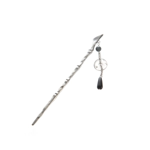 Detailed view of silver bamboo-style hair pin with tassel and black teardrop charm