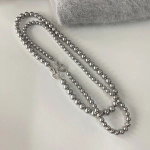 Close-up of double-layered grey pearl necklace with sparkling cubic zirconia clasp
