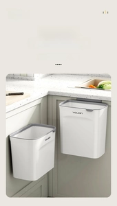 Detail of hanging kitchen trash cans in medium and large sizes with minimalist white finish