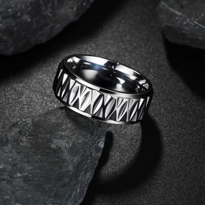 Vintage geometric engraved silver metal ring for men with industrial texture on dark stone
