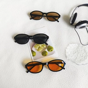 Retro oval sunglasses in black, brown, and orange lenses with high-quality black frames