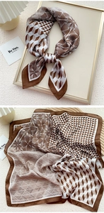 Detail of coffee and cream silk scarf with geometric patterns in a chic French setup