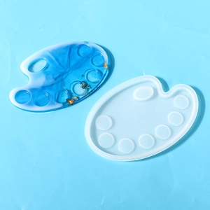 Macro view of a palette-shaped silicone resin mold with a blue marble finished piece