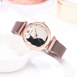 Close-up of rose gold mesh watch featuring a black cat pattern and sparkling rhinestone