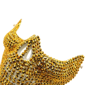 Detailed close-up of a sparkling gold rhinestone masquerade mask for Halloween party
