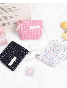 Detail of tweed coin purses with sequins, pearl pendants and elegant setup