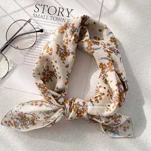 Detailed close-up of a floral cotton linen scarf with vintage flower print and texture