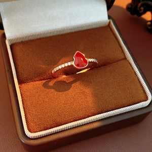 Macro view of 18k gold-plated gourd ring with red enamel and pavé zircon stones
