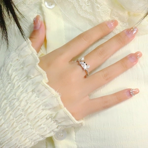 Sparkling crab ring with silver finish and white crystals on a hand for ocean-themed style