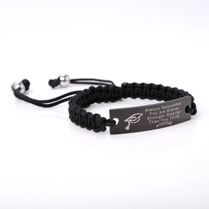 Detail of adjustable black braided bracelet with engraved inspirational message for graduates