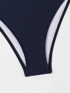 Detailed view of dark blue bikini bottom featuring high-stretch fabric and reinforced stitching