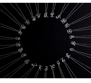 Detailed circular layout of silver 925 alphabet pendants with sparkling zircon stones