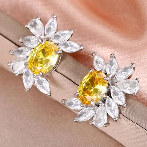Macro view of sunflower earrings with yellow zircon and marquise-cut petals