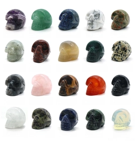 Grid display of 20 natural crystal skull carvings in various gemstones and colors