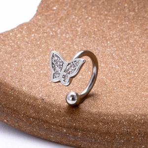 Detailed macro view of silver steel butterfly ear cuff set with sparkling zircon stones
