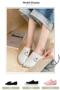 Close-up of white cotton low-cut sock featuring a cute cartoon dog motif on the instep