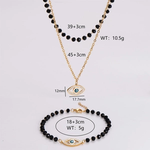 Golden evil eye necklace and bracelet set with black beads and crystal pendants