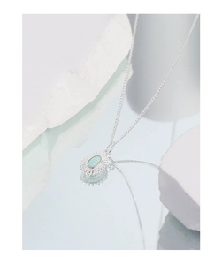 Macro shot of silver sunflower necklace featuring a vibrant blue opal stone pendant