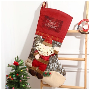 Detail of a large Christmas stocking with a 3D Santa doll on a rustic wooden ladder