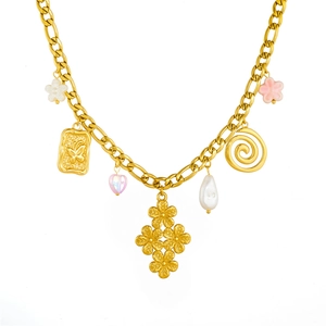 Gold-plated necklace with butterfly charm, floral pendants, and pearls on white background