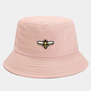 Close-up of a pink bucket hat featuring a detailed yellow and black bee embroidery