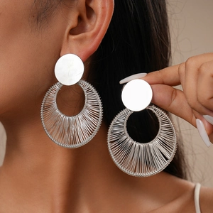 Silver hollow intertwined round earrings featuring a metallic wire-wrap fashion design