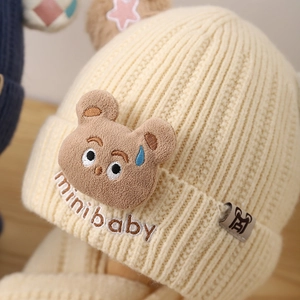 Winter knitted bear hat for kids featuring cute plush bear patch and soft ribbed texture