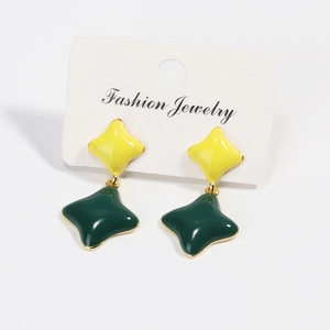 Detail view of gold-plated four-leaf clover stud earrings with green enamel and yellow resin