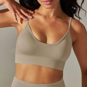 Close-up of seamless ribbed sports bra with thin straps and deep V-neck in coffee brown