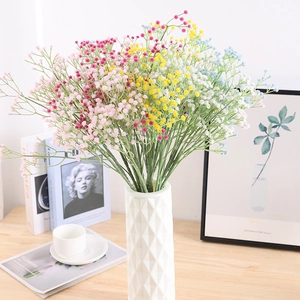 Colorful artificial baby's breath bouquet in a white geometric vase for home decor