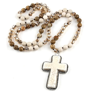 Detail of bohemian prayer necklace with white stone cross pendant and beaded chain