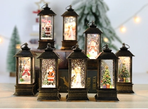 Retro bronze Christmas snow globe lanterns with glowing interior scenes and glitter