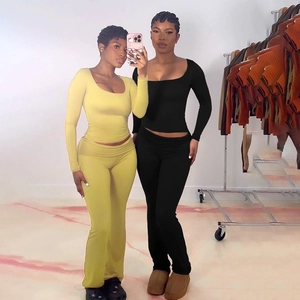 Detail of slim-fit square-neck long-sleeve knit top and pants set for women in yellow and black
