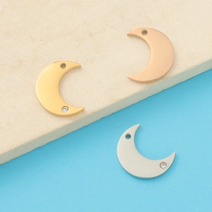 Moon pendants in rose gold, gold, and silver finishes with crystal accents on stone