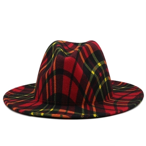Detail of red and green tartan wool fedora hat with classic plaid pattern texture