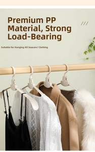 Detail of cream-colored wide non-slip hangers made of durable PP material on a wooden rod