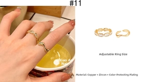 Detail of adjustable gold ring set featuring zircon inlay and wavy sleek design